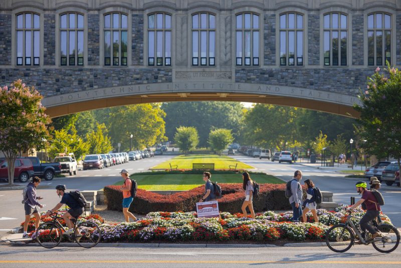 Students walking under Torgersen Bridge