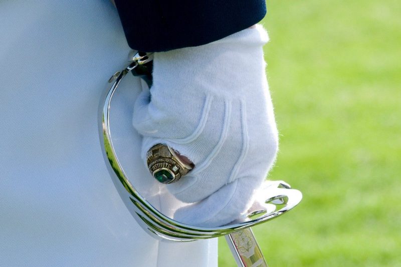 A cadet brandishes a class ring.