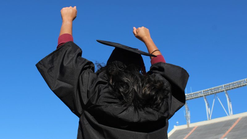 graduate with hands in the air