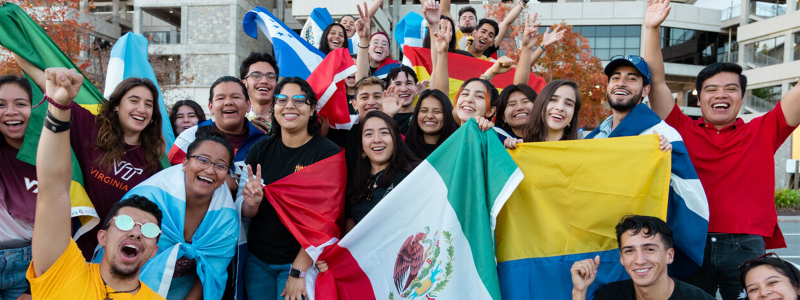 students smiling and posing with flags