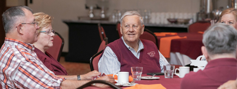 Cornerstone alumni eating around a table