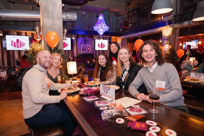 Young alumni sit at a table during the Pylon Society Celebration