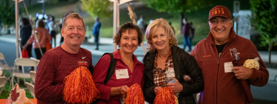 Four Hokies pose for a photo at Homecoming 2023