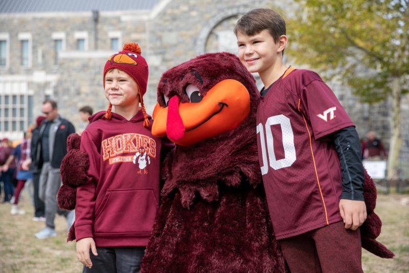 HokieBird poses for a photo with two children