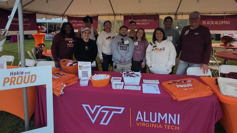 Alumni pose for a picture during a tailgate at the Black Alumni Reunion