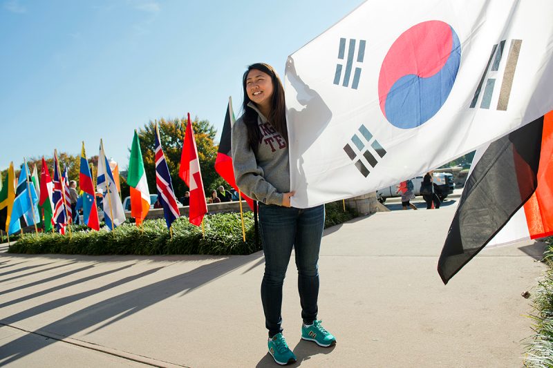 A Virginia Tech student holds up a Japanese flag
