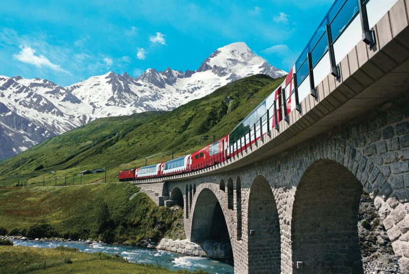 train on a trestle in front of a mountain