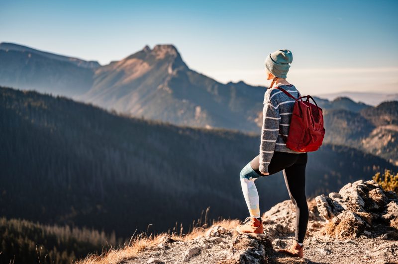 Person on top of a mountain looking out at the view