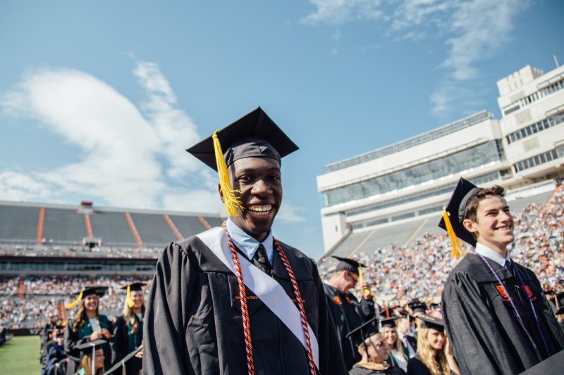 two graduates smiling