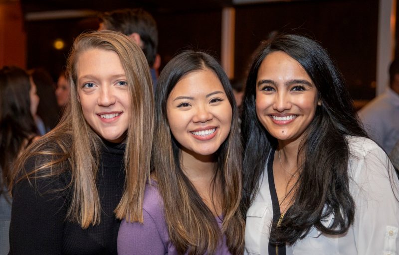 three young alumni smiling