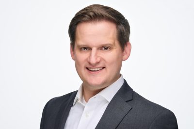 A headshot of Jacob Kocher on a white background